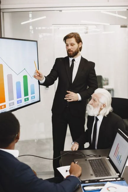 Team working on marketing strategy using data charts and papers in an office meeting.